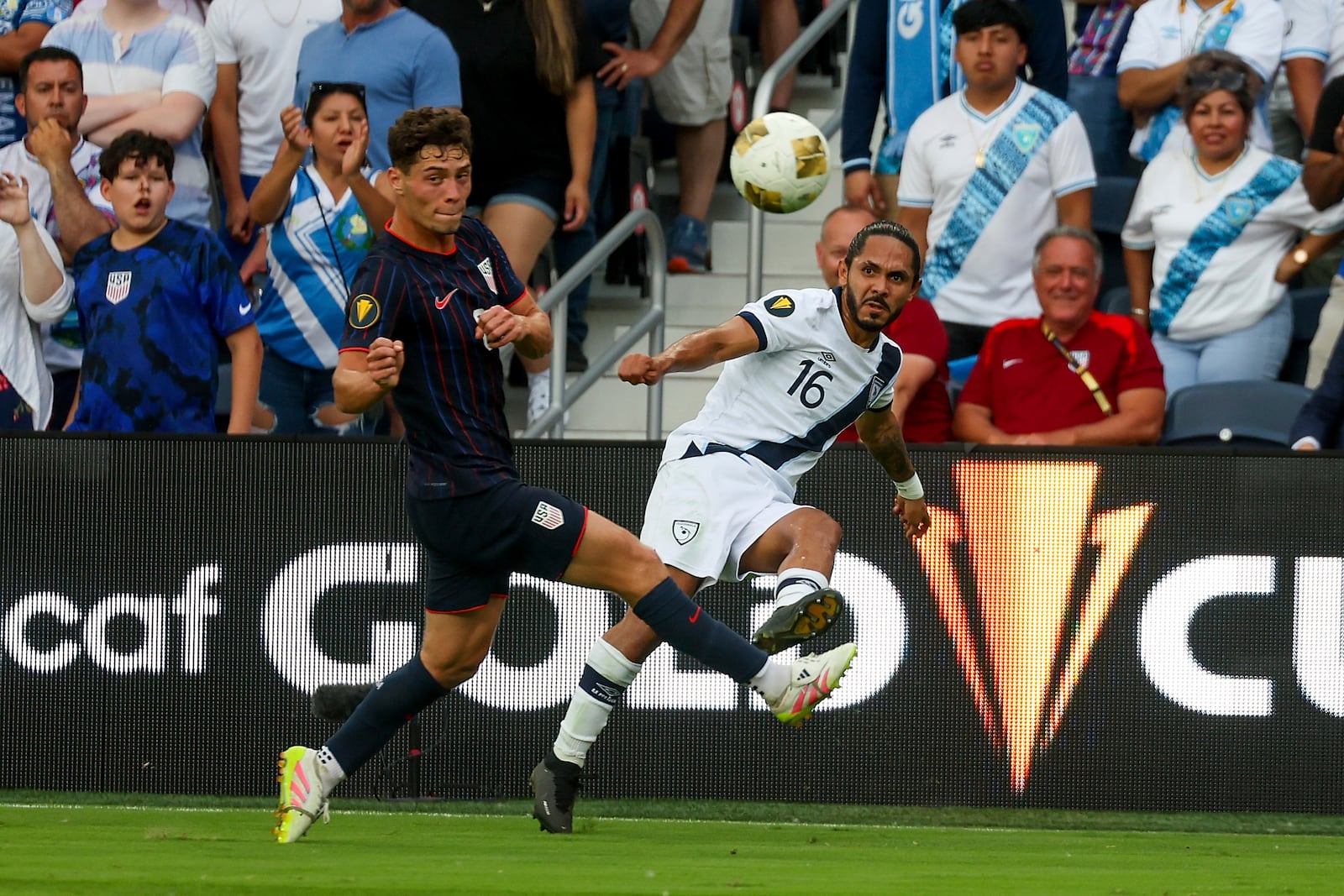 Guatemala defender Jose Morales (16) clears the ball while under pressure from United States midfielder Sebastian Berhalter, left, during the first half of a CONCACAF Gold Cup semifinal soccer match, Wednesday, July 2, 2025, in St. Louis. (AP Photo/Scott Kane)