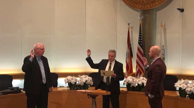 Middletown Municipal Court Judge James Sherron swears in Rodney Muterspaw, left, and Zack Ferrell as newly-elected members of Middletown City Council Tuesday night in City Council Chambers. RICK McCRABB/STAFF