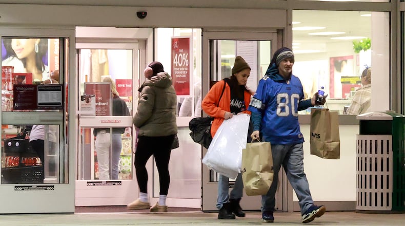 Shoppers walk out of Kohls on North Bechtle Avenue with their arms full of packages on Black Friday. BILL LACKEY/STAFF