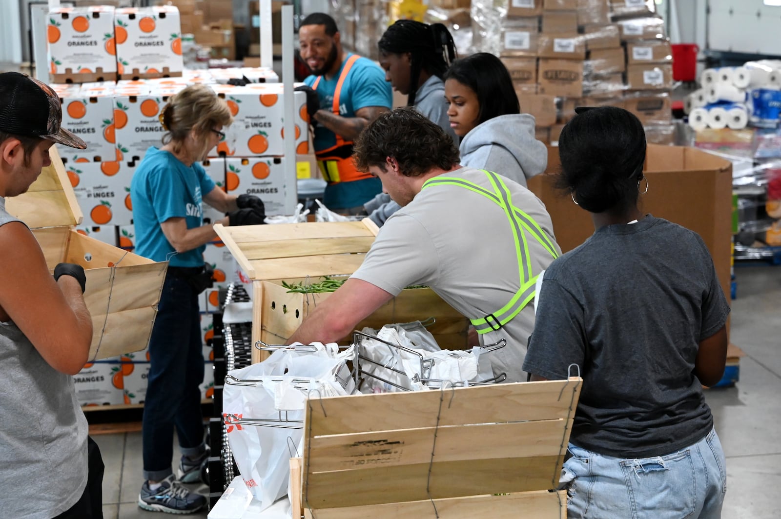 Pictured are volunteers at Shared Harvest Foodbank in Fairfield, Ohio, on Wednesday, July 9, 2025, packaging food in preparation for distribution. The federal cut to Supplemental Nutrition Assistance Program, or SNAP, benefits with the passage of the so-called "One Big Beautiful Bill" approved by Congress and signed by President Donald Trump, organizations like Shared Harvest expect to see an increase in clients as federal food supplies decrease. "Our greatest concern is that we continue in the pattern of reducing food sources, and we continue to see growing numbers of people coming to our network,” said Shared Harvest Executive Director Terry Perdue. “It’s less food and more people needing access to charitable food.” MICHAEL D. PITMAN/STAFF