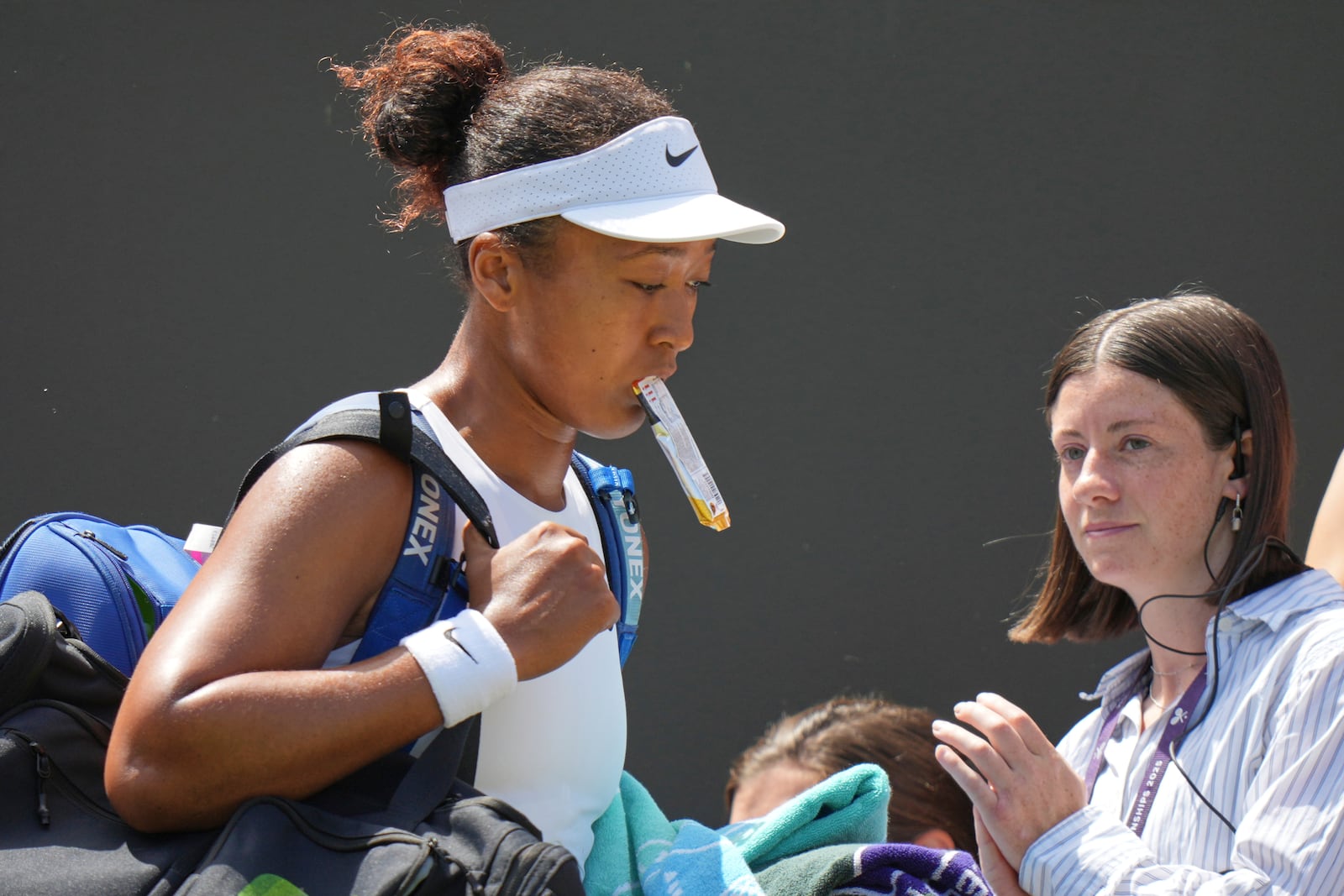 Naomi Osaka of Japan leaves the court after losing to Russia's Anastasia Pavlyuchenkova during a third round women's singles match at the Wimbledon Tennis Championships in London, Friday, July 4, 2025. (AP Photo/Alastair Grant)