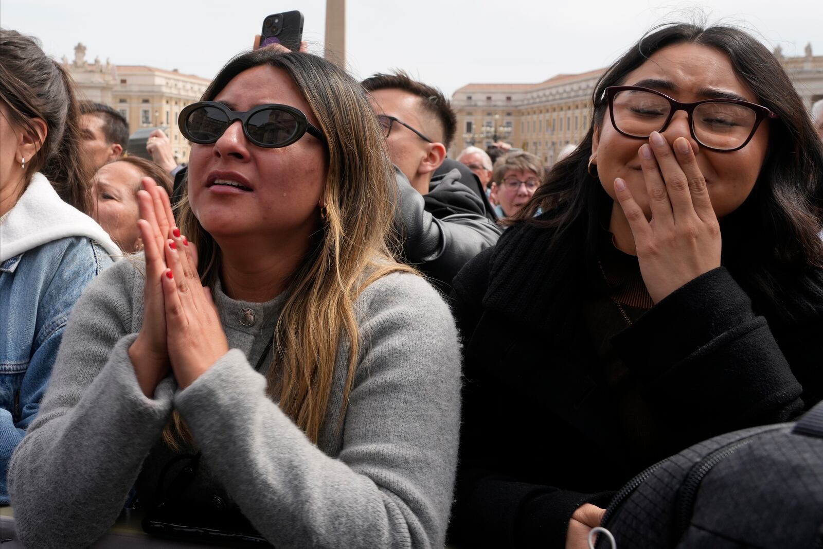 Faithful get emotional as Pope Francis arrives at the end of the mass on Palm Sunday in St. Peter's Square at The Vatican, Sunday, April 13, 2025. (AP Photo/Gregorio Borgia)