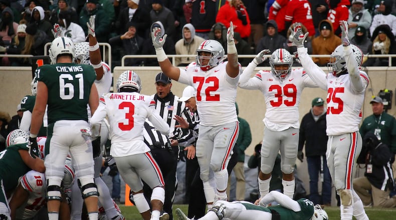 EAST LANSING, MI - NOVEMBER 10: Rocky Lombardi #12 of the Michigan State Spartans lays on the ground as the Ohio State Buckeyes celebrate a fourth quarter fumble recovery for a touchdown at Spartan Stadium on November 10, 2018 in East Lansing, Michigan. (Photo by Gregory Shamus/Getty Images)