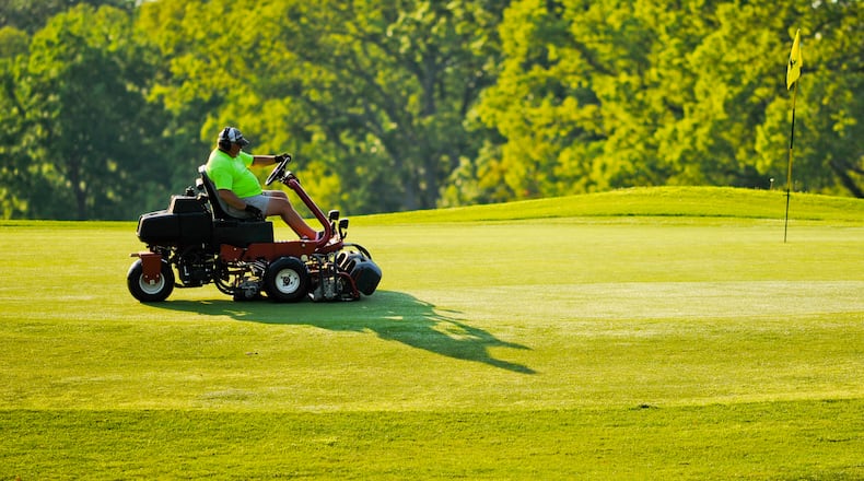 Hamilton bought specialized mower-blade sharpeners for about $10,000 from Middletown’s Weatherwax Golf Course after it closed last November. Pictured is an employee cutting the greens at Potter’s Park golf course in Hamilton. STAFF FILE PHOTO