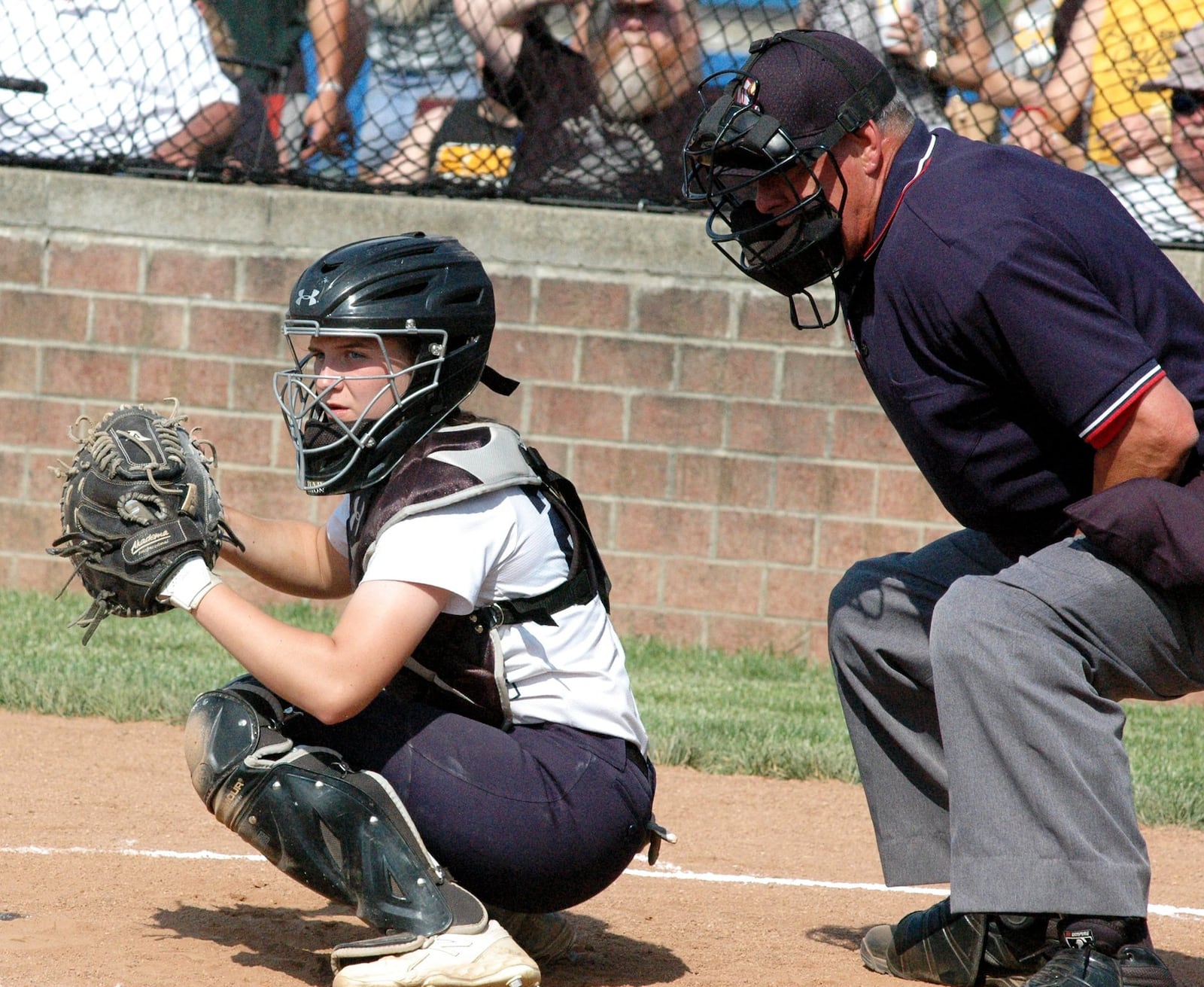 Monroe catcher Sam Schwab works behind the plate Saturday during a 4-0 win over Springfield Shawnee in a Division II district championship softball game at Brookville. RICK CASSANO/STAFF