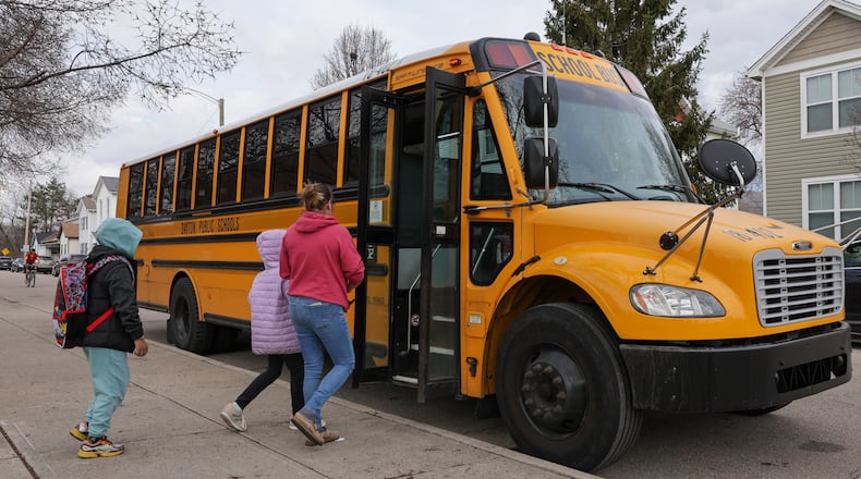 Ruskin Elementary School students board a bus on Friday, March 6 on McClure Street in Dayton. A bill in the Ohio House would provide $88 million for school transportation. BRYANT BILLING / STAFF