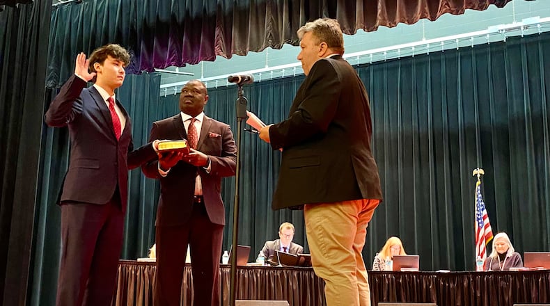 A recent Lakota high school graduate, now Miami University freshman, made history Monday evening by being sworn in to his publicly elected seat on the Lakota school board. Benjamin Nguyen, a 2025 graduate of Lakota West High School, placed his hand on a Bible and recited an office holder’s oath prior to the Lakota Board of Education meeting, becoming the youngest board member in the school system’s 60-plus years of existence. (Photo By Michael D. Clark/Journal-News)