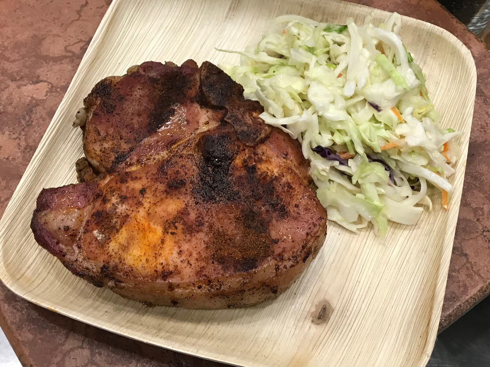 Smoked Bone-In Chop at Great American Ball Park: A 14-ounce porterhouse pork chop with coleslaw on the side. CONTRIBUTED
