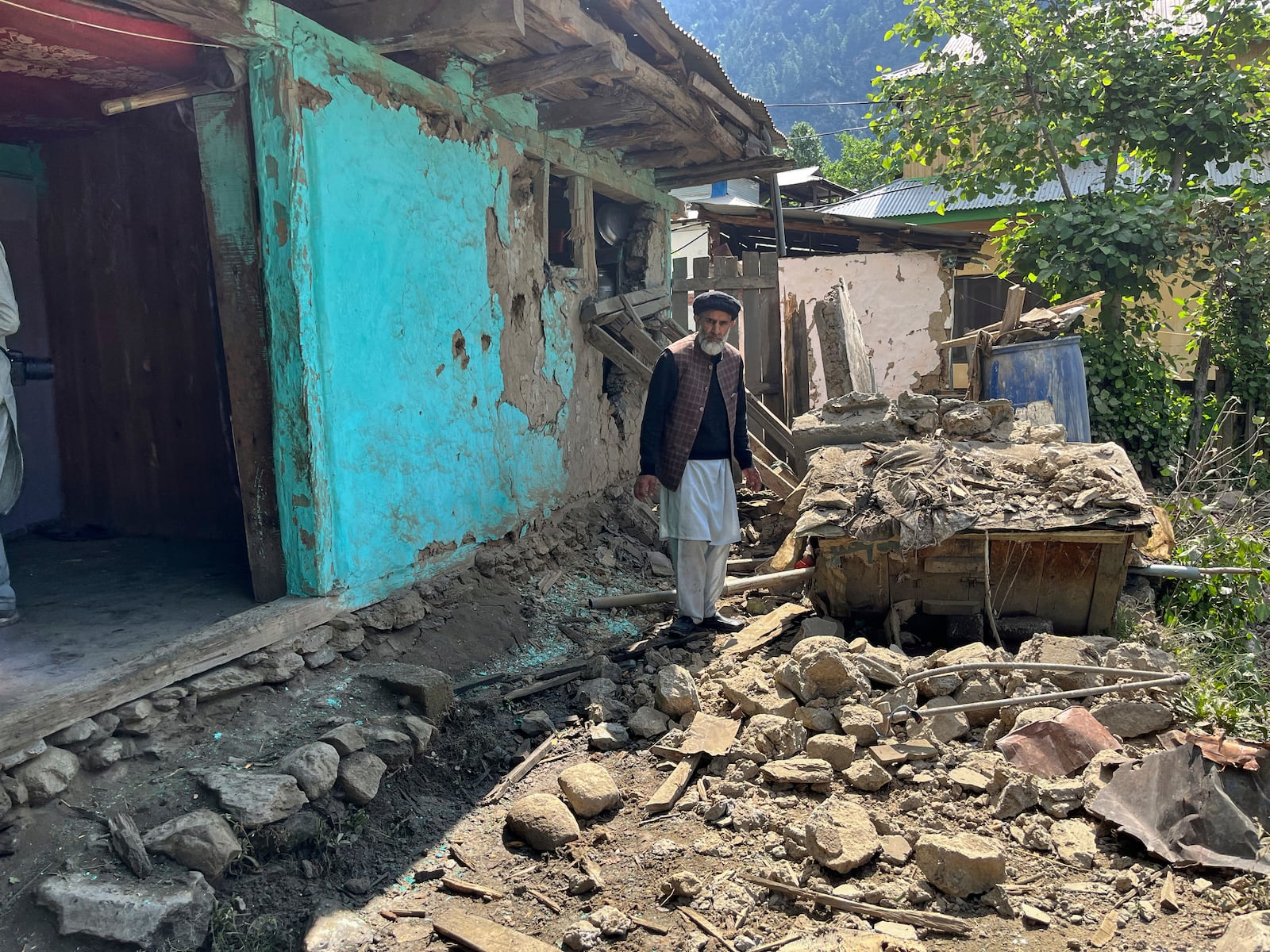 A Kashmiri villager examines damages to his house caused by overnight Indian shelling, in Shah Kot, in Neelum Vallery, a district of Pakistan's administered Kashmir, Saturday, May 10, 2025. (AP Photo/M.D. Mughal)