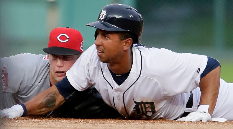 DETROIT, MI - JUNE 15: Jon Moscot #46 of the Cincinnati Reds and Anthony Gose #12 of the Detroit Tigers lie at second base after Moscot made a diving tag on Gose during the first inning at Comerica Park on June 15, 2015 in Detroit, Michigan. Moscot dislocated his left, non-throwing shoulder on the play. (Photo by Duane Burleson/Getty Images)