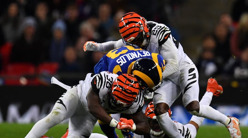 LONDON, ENGLAND - OCTOBER 27: Josh Reynolds #83 of the Los Angeles Rams is tackled by Jessie Bates #30 of the Cincinnati Bengals and Tony McRae #29 of the Cincinnati Bengals during the NFL London Games series match between the Cincinnati Bengals and theLos Angeles Rams at Wembley Stadium on October 27, 2019 in London, England. (Photo by Justin Setterfield/Getty Images)