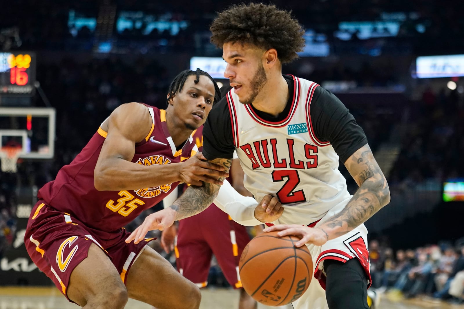 FILE - Chicago Bulls' Lonzo Ball (2) drives against Cleveland Cavaliers' Isaac Okoro (35) in the first half of an NBA basketball game, Dec. 8, 2021, in Cleveland. (AP Photo/Tony Dejak, File)