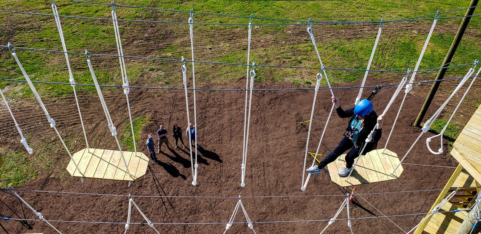 Patricia Dawson, public relations coordinator for Butler County Board of Developmental Disabilities, climbs on the Great Miami Valley YMCA's high ropes course now open at Camp Campbell Gard Wednesday, May 15, 2019 on Augspurger Road in St. Clair Township. The course stands nearly fifty feet tall with three levels of elements ranging in difficulty. There is also a climbing wall, zip line, giant swing and more. The course has a universal access system allowing participants with all abilities, including those in wheel chairs, the opportunity to experience it. NICK GRAHAM/STAFF