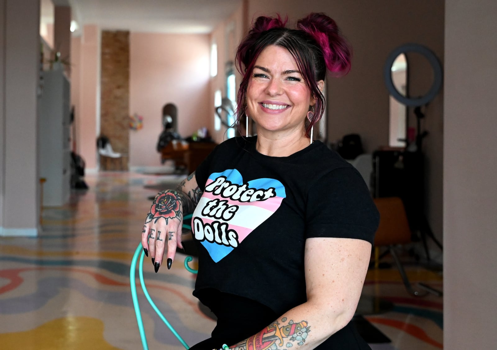 Biz Jarvis, the owner of Hue Mane Salon in the Lindenwald neighborhood of Hamilton, has been a champion of her hometown city, including her annual back to school haircut events, which was held on Aug. 10, 2025, this year, for community's youth through a "Pay What You Can" model, even if it's nothing. She's also a strong supporter of the LGBTQ+ community. MICHAEL D. PITMAN/STAFF