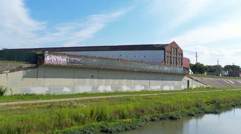 The Hamilton StreetSpark program is asking artists to submit qualifications for one of the largest murals the iniatitive plans to undertake. Pictured is the levee wall by the site that will be the Crawford Hoying development across from Spooky Nook. NICK GRAHAM/STAFF