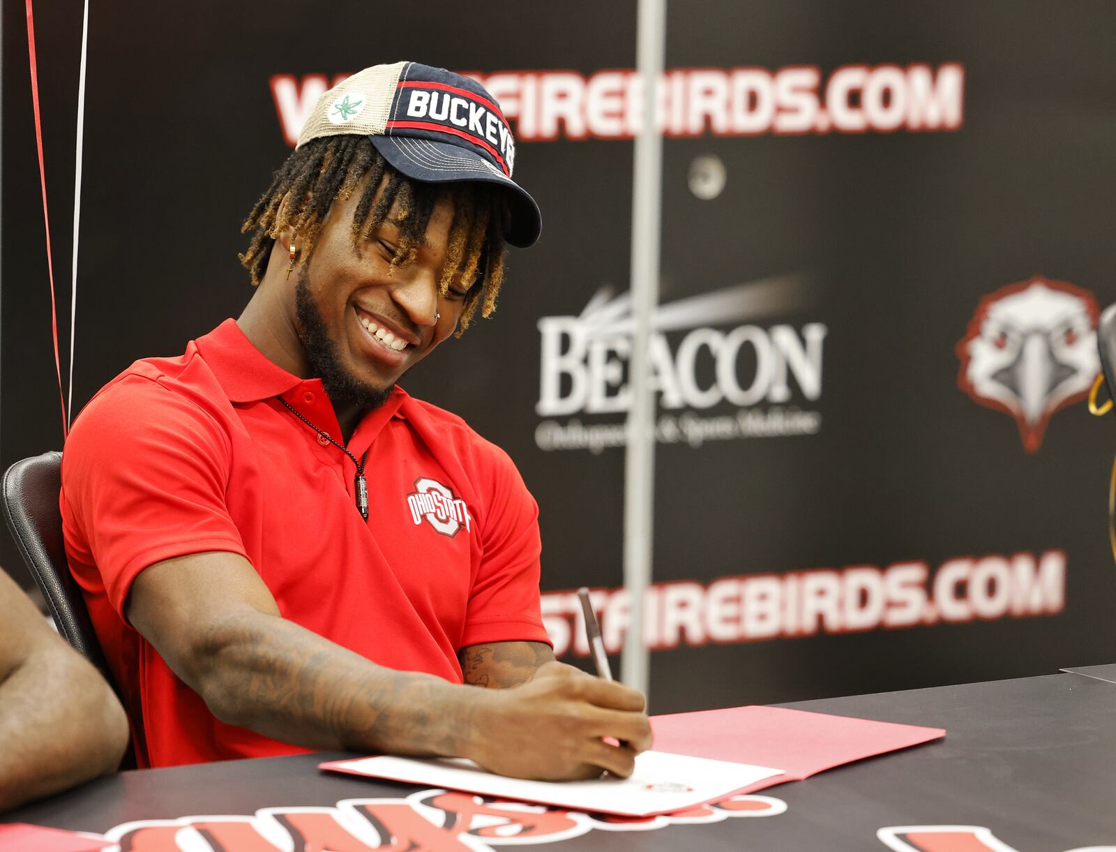 Lakota West's Jyaire Brown sits during a national letter of intent college football signing ceremony Wednesday, Dec. 15, 2021 at Lakota West High School. Brown is signing with The Ohio State University. NICK GRAHAM / STAFF