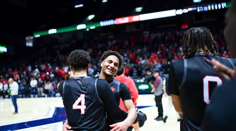 Lakota West's Isaiah Meade-Moss (4) and Tyson Davis celebrate after the Firebirds beat the Fairfield Indians 45-40 in a Division I regional final on Sunday at Xavier University's Cintas Center. Chris Vogt/CONTRIBUTED