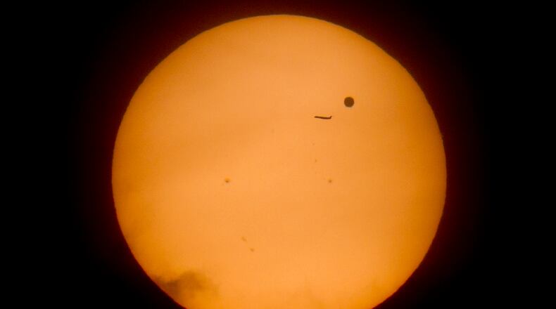 A regional jet passed in front of Venus in this June 5, 2012 file photo shot through a Baader Solar Filter.