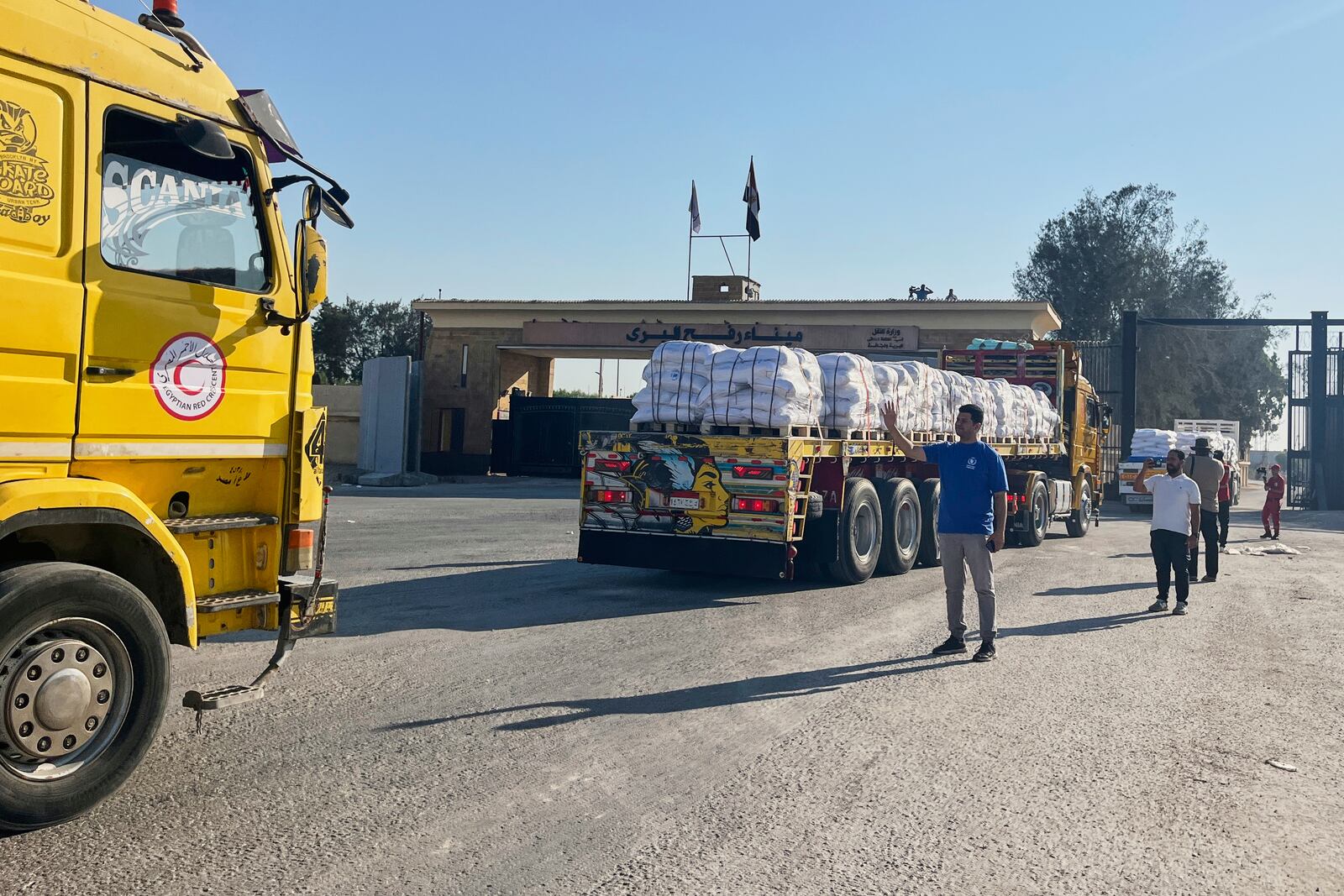 Trucks carrying humanitarian aids enter the Rafah crossing between Egypt and the Gaza Strip, Sunday, July 27, 2025. (AP Photo/Mohamed Arafat)