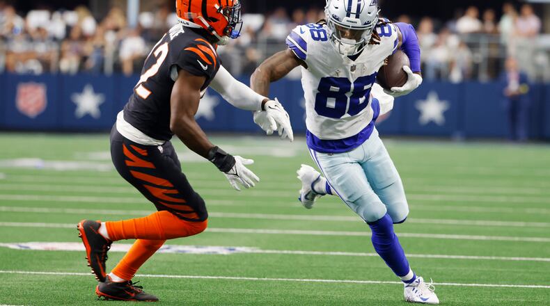 Dallas Cowboys wide receiver CeeDee Lamb (88) looks for yardage after a catch as Cincinnati Bengals cornerback Chidobe Awuzie (22) closes in during the first half of an NFL football game Sunday, Sept. 18, 2022, in Arlington, Tx. (AP Photo/Ron Jenkins)