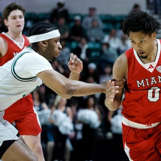 Miami (OH) forward Eian Elmer (0) drives to the basket against Eastern Michigan guard Gregory Lawson, left, during the first half of an NCAA college basketball game Tuesday, Feb. 24, 2026, in Ypsilanti, Mich. (AP Photo/Duane Burleson)