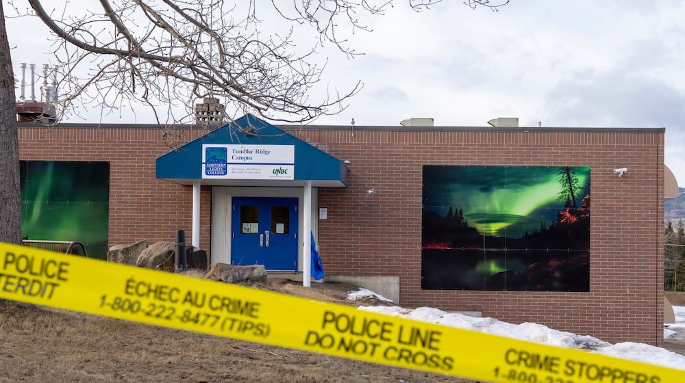 Police tape surrounds a school in Tumbler Ridge, British Columbia, Canada, on Thursday, Feb. 12, 2026, after Tuesday's mass shooting. (Christinne Muschi/The Canadian Press via AP)