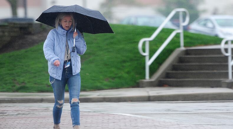 An umbrella helped keep some of the rain off a woman walking on Brown Street Monday, April 12, 2020. MARSHALL GORBY\STAFF