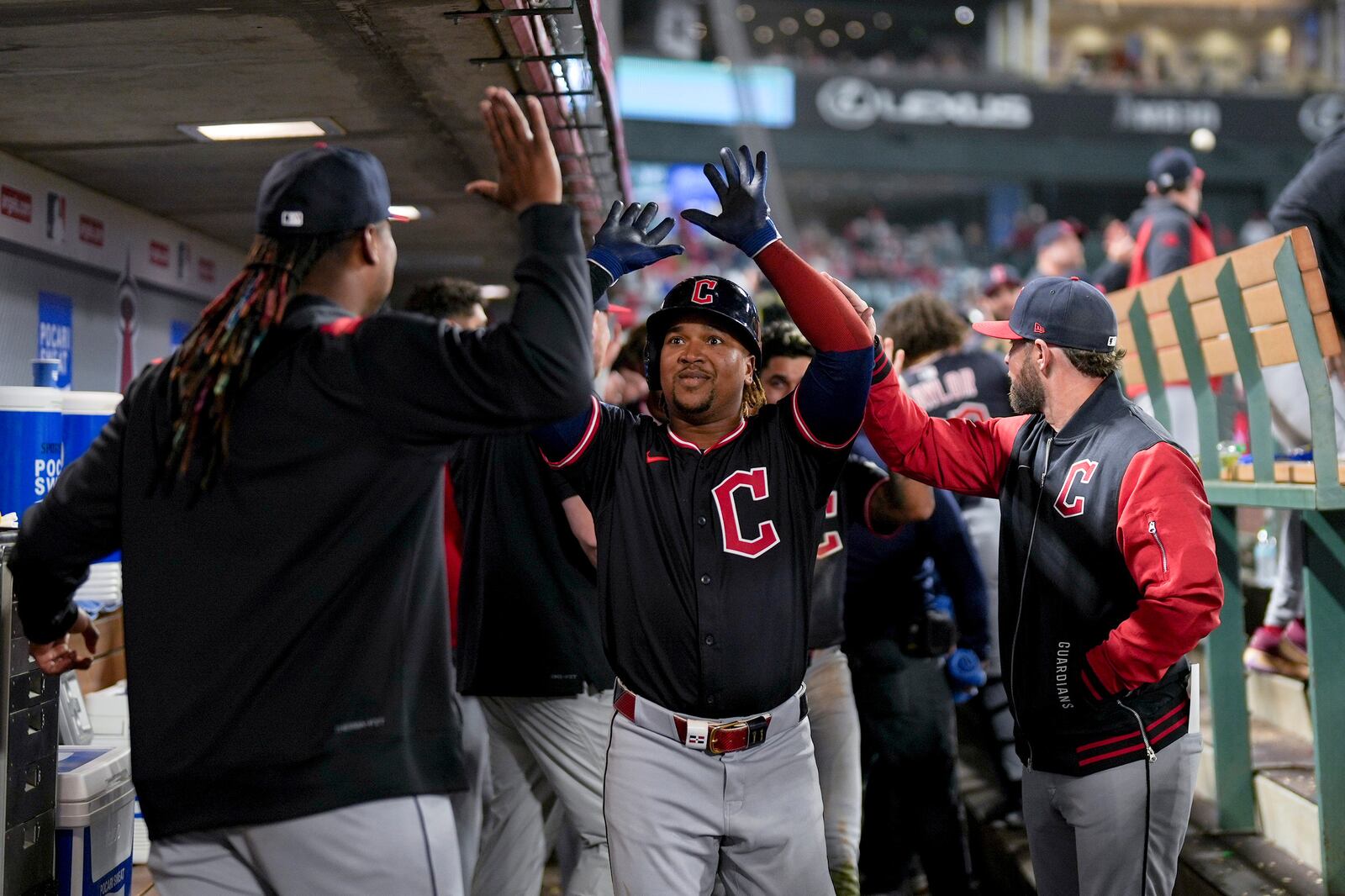 Cleveland Guardians Jose Ramirez, center, celebrates with teammates in the dugout after hitting a home run during the ninth inning of a baseball game against the Los Angeles Angels in Anaheim, Calif., Friday, April 4, 2025. (AP Photo/Eric Thayer)