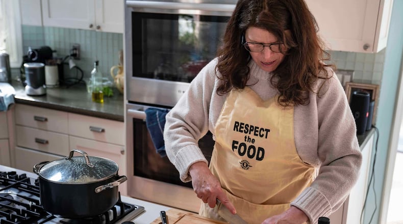 CEO of the Chef Ann Foundation, Mara Fleishman, a winner of this year's Elevate Prize, chops apples for a salad at her home, Monday, Feb. 16, 2026, in Boulder, Colo. (AP Photo/Rebecca Slezak)