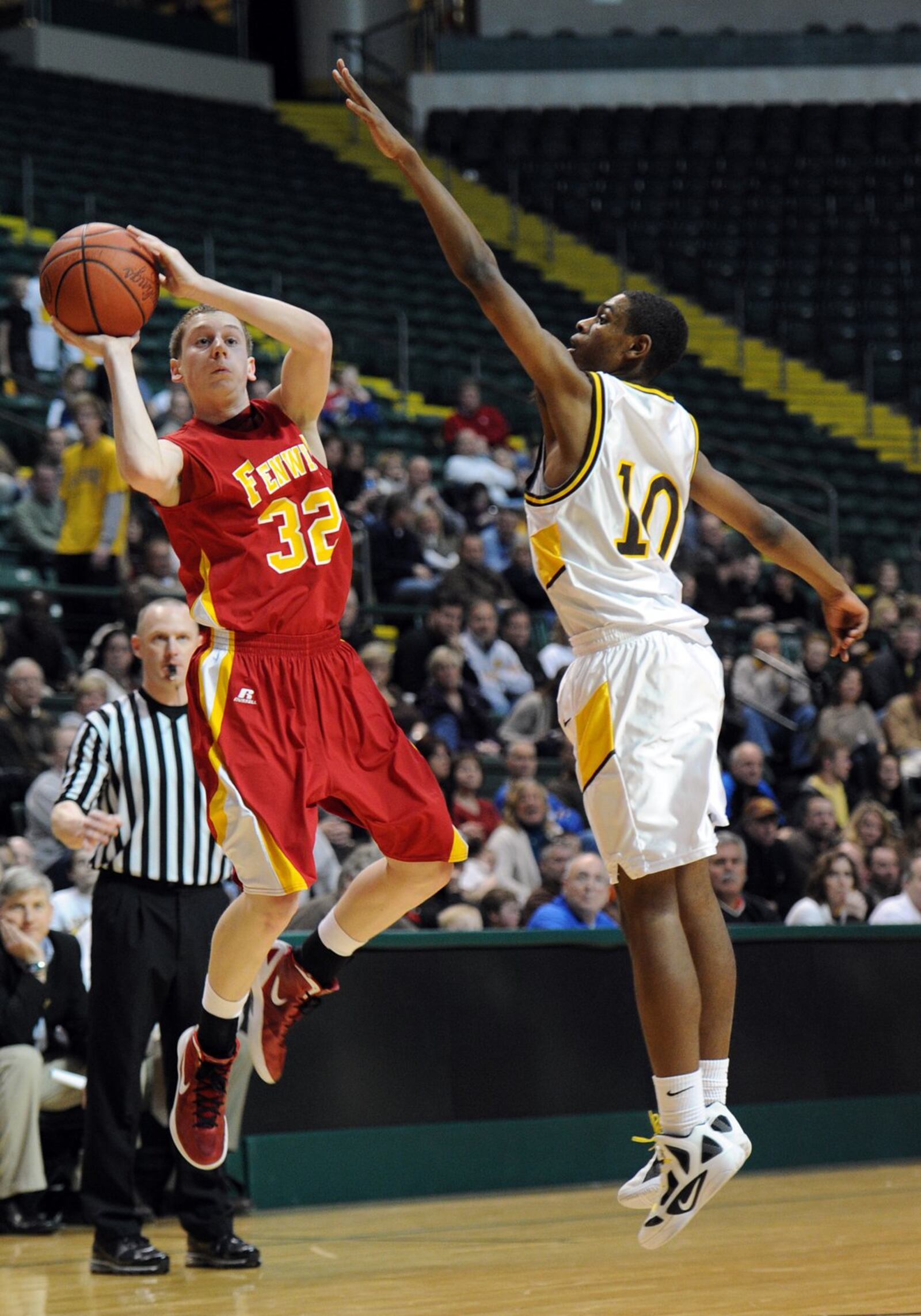 Fenwick’s Kevin Christie (left) attempts a shot while being guarded by Alter’s Michael Spencer during a game at Wright State University’s Nutter Center on Feb. 4, 2012. COX MEDIA FILE PHOTO