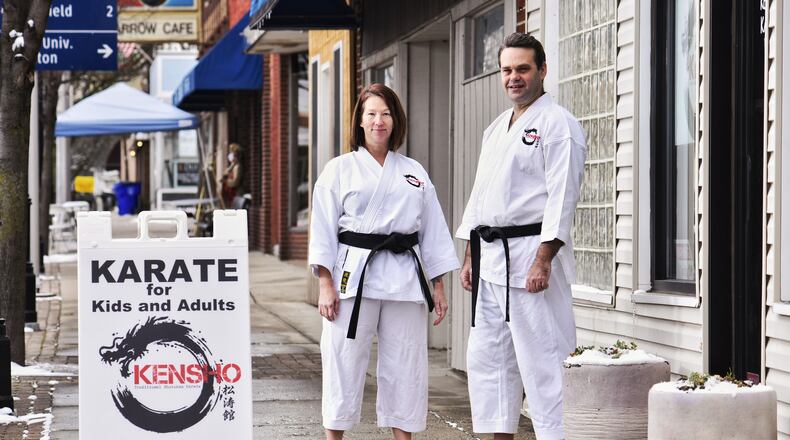 Jane Curry and Kevin Downard stand outside their business, Kensho Traditional Shotokan Karate, on Pleasant Avenue in the Lindenwald neighborhood of Hamilton. NICK GRAHAM / STAFF
