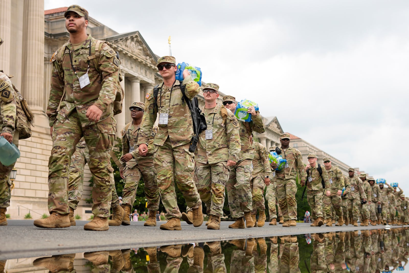 U.S. Army soliders walking along Constitution Ave., on the National Mall ahead of a parade commemorating the Army's 250th annversary and coninciding with President Donald Trump's 79th birthday, Saturday, June 14, 2025, in Washington. (AP Photo/Pablo Martinez Monsivais)