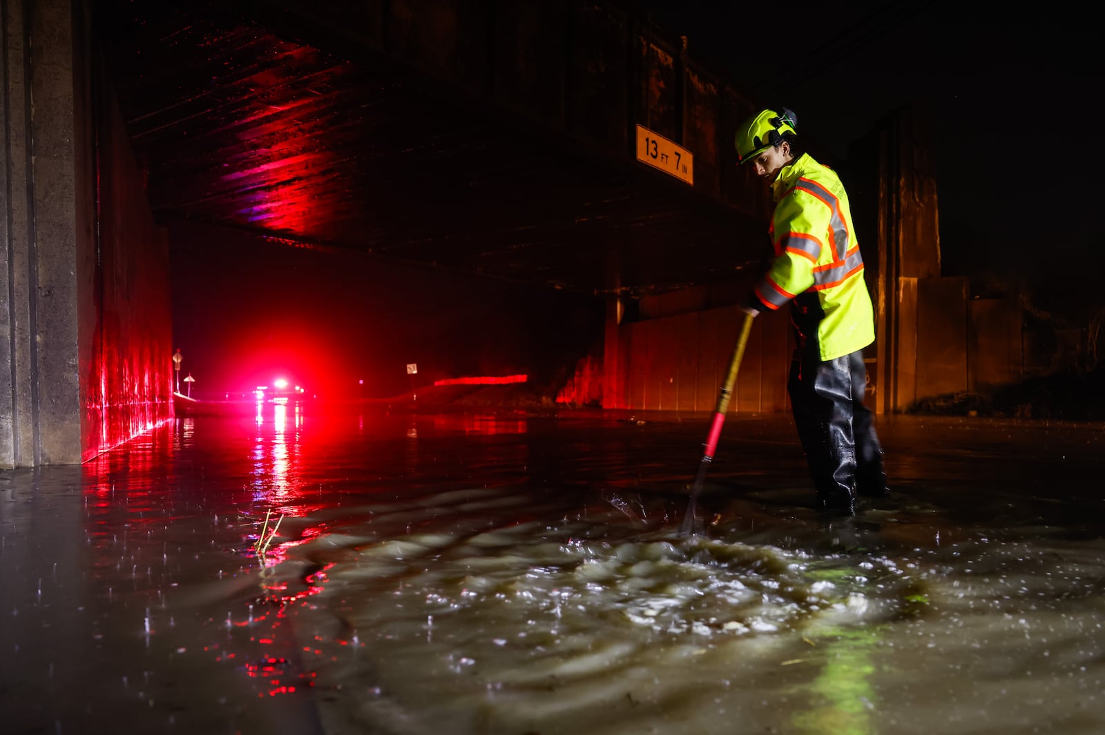 Dustin Carpenter from Ohio Department of Transportation works to clear drains on a flooded Germantown Road early Thursday morning, March 5, 2026 in Madison Township in Butler County. Heavy rain caused flooding in many areas. NICK GRAHAM/STAFF