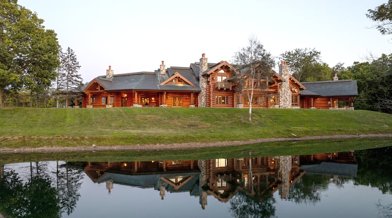 The 7,000-square-foot log home with a pond in front and inground pool and courtyard in back was handcrafted by master builders using British Columbia timber and stone from the Snake River in western Wyoming. The log home and equestrian facility are on a 189-acre property with one mile of Little Miami River frontage in Warren County. CONTRIBUTED