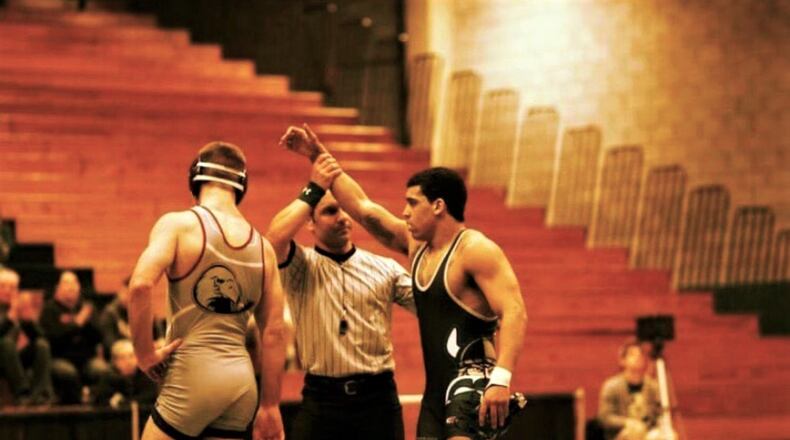 Former Middletown High School wrestler LaTrell Davis has his hand raised after a victory. CONTRIBUTED