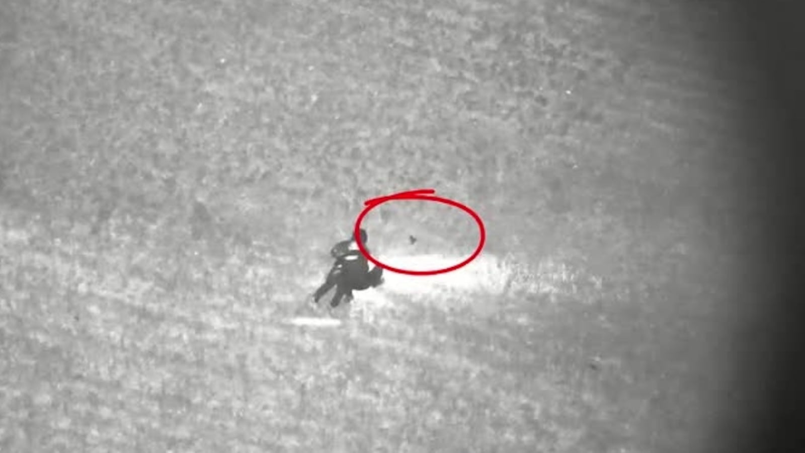 A Springboro officer finds a loaded firearm (circled in red) after the department's drone leads police to three armed suspects early Wednesday, May 7, 2025. CONTRIBUTED