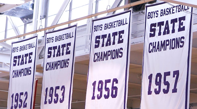Banners for four of the five state championships Paul Walker led his Middletown High School teams to are pictured in Wade E. Miller Gymnasium. Walker finished his 40-year career with a 695-169 record and still ranks third all-time in the state of Ohio. He was 562-136 in 30 years with the Middies. Walker led the Middies to five state basketball championships: 1947, ‘52, ‘53, ‘56 and ‘57. NICK GRAHAM/STAFF
