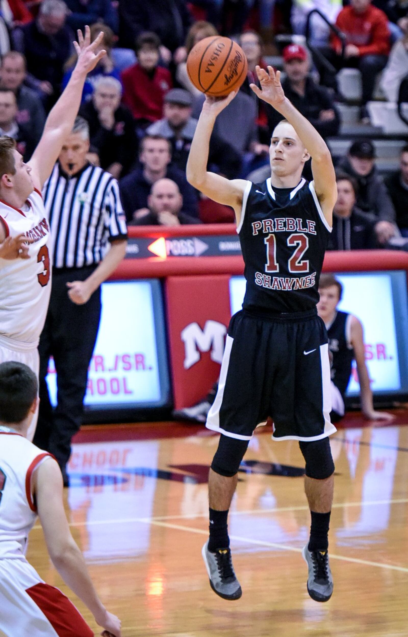 Preble Shawnee’s Kevin Ketring puts up a jumper over Madison’s Mason Whiteman during Friday night’s game at Madison. NICK GRAHAM/STAFF