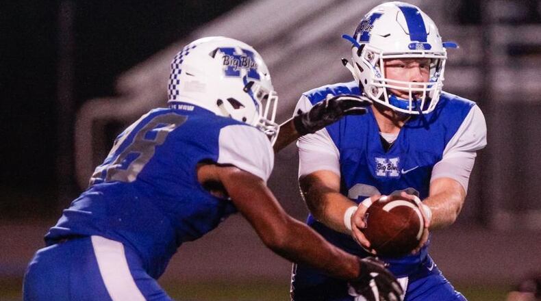 Hamilton quarterback Elijah Spradling hands off to Keyshawn Stephens during last Friday’s 15-14 victory over Middletown at Virgil Schwarm Stadium in Hamilton. NICK GRAHAM/STAFF