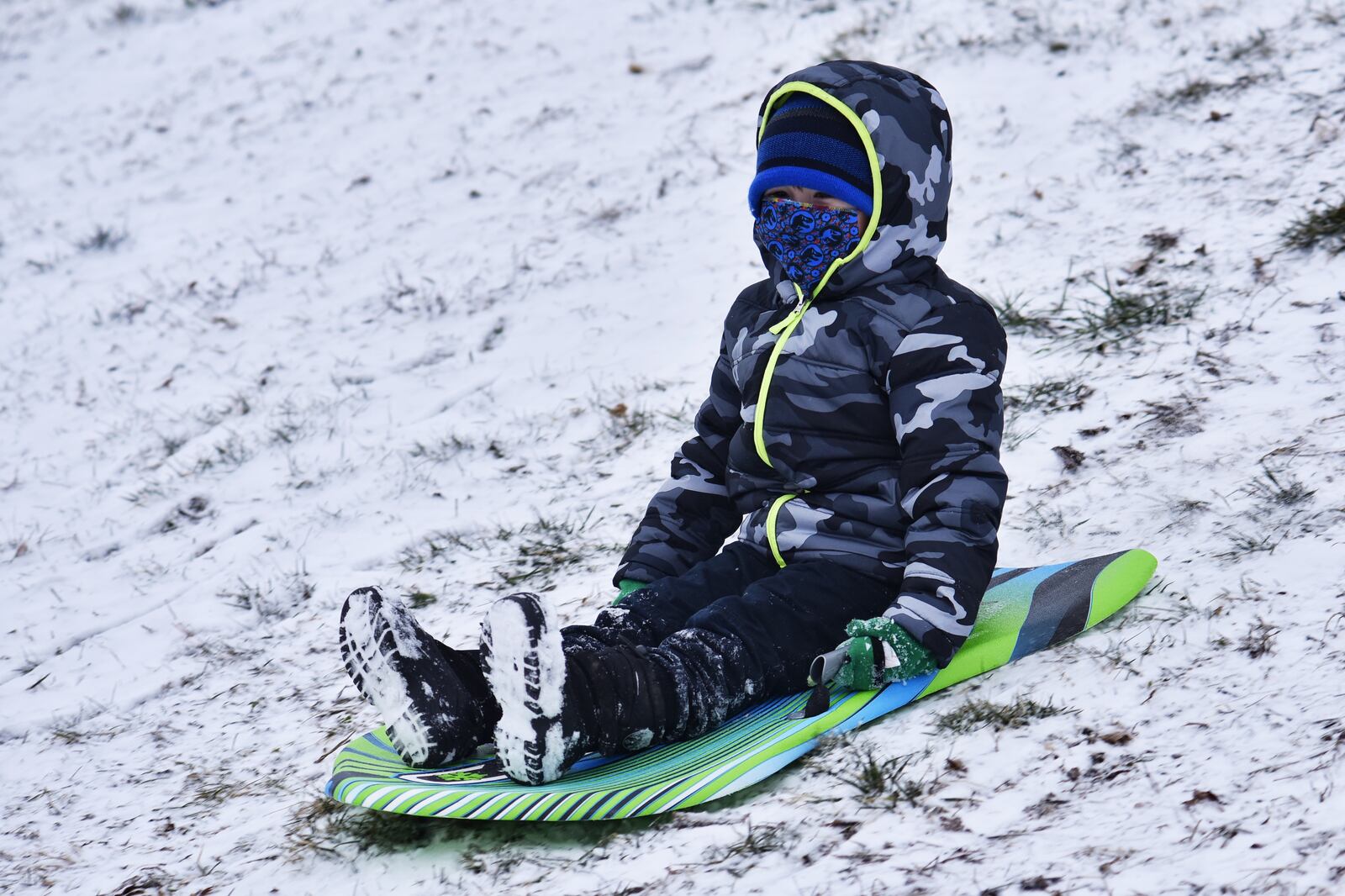 Oliver Crabtree, 4, sleds down a hill Monday, February 1, 2021. at Sunset Park in Middletown. NICK GRAHAM / STAFF