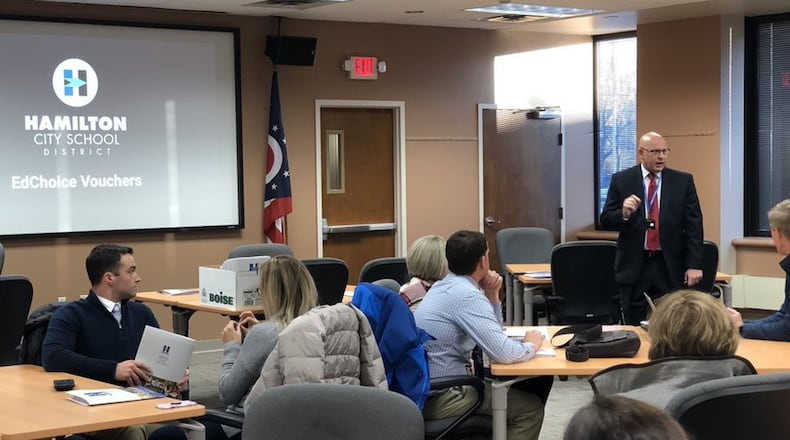 Hamilton Schools Superintendent Mike Holbrook, standing, briefs school principals from the Butler County school system about the ramifications of the state’s new Ed Choice program. Area school officials are joining a growing statewide chorus of objection to changes in the program, which designates many previously high-rated schools as now deficient enough in some areas to allow school parents to be paid by public districts to enroll their children in private schools. (Provided Photo/Journal-News)