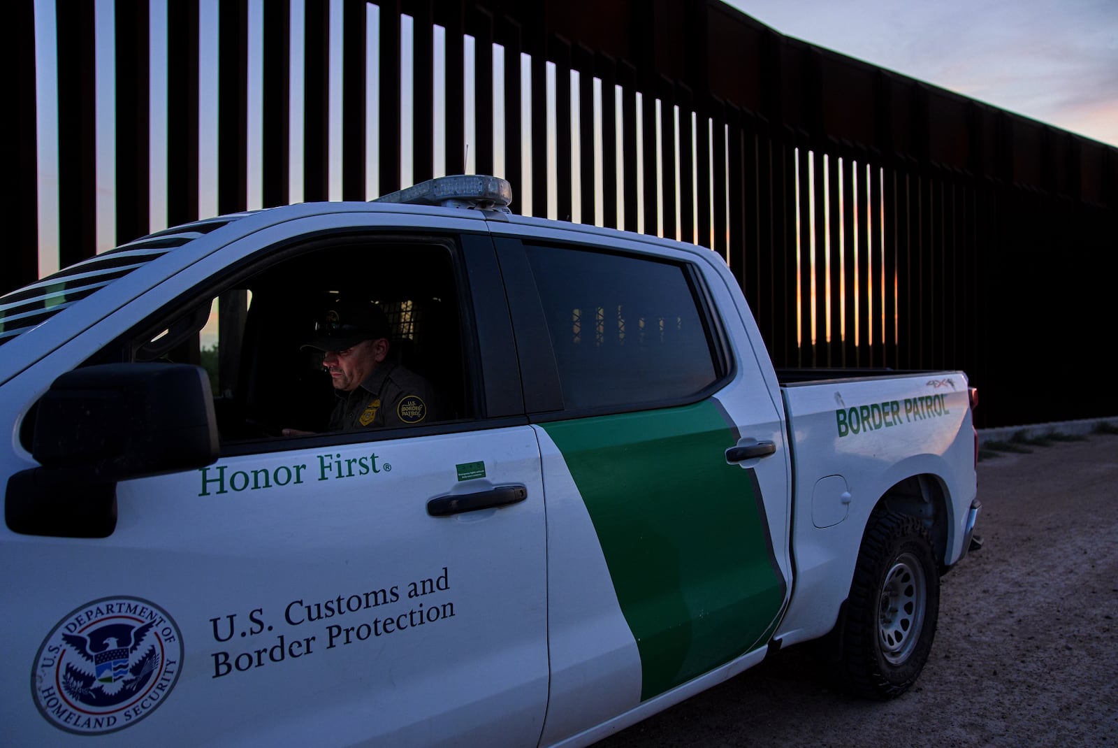 A border patrol agent works by a section of the border wall, Wednesday, June 18, 2025, in Mission, Texas. (AP Photo/Jacquelyn Martin)