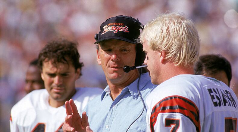 ANAHEIM, CA - OCTOBER 7: Head coach Sam Wyche of the Cincinnati Bengals talks to his quarterback Boomer Esiason #7 on the sidelines during a game against the Los Angeles Rams at the Anaheim Stadium on October 7, 1990 in Anaheim, California. The Bengals won 34-31. (Photo by George Rose/Getty Images)