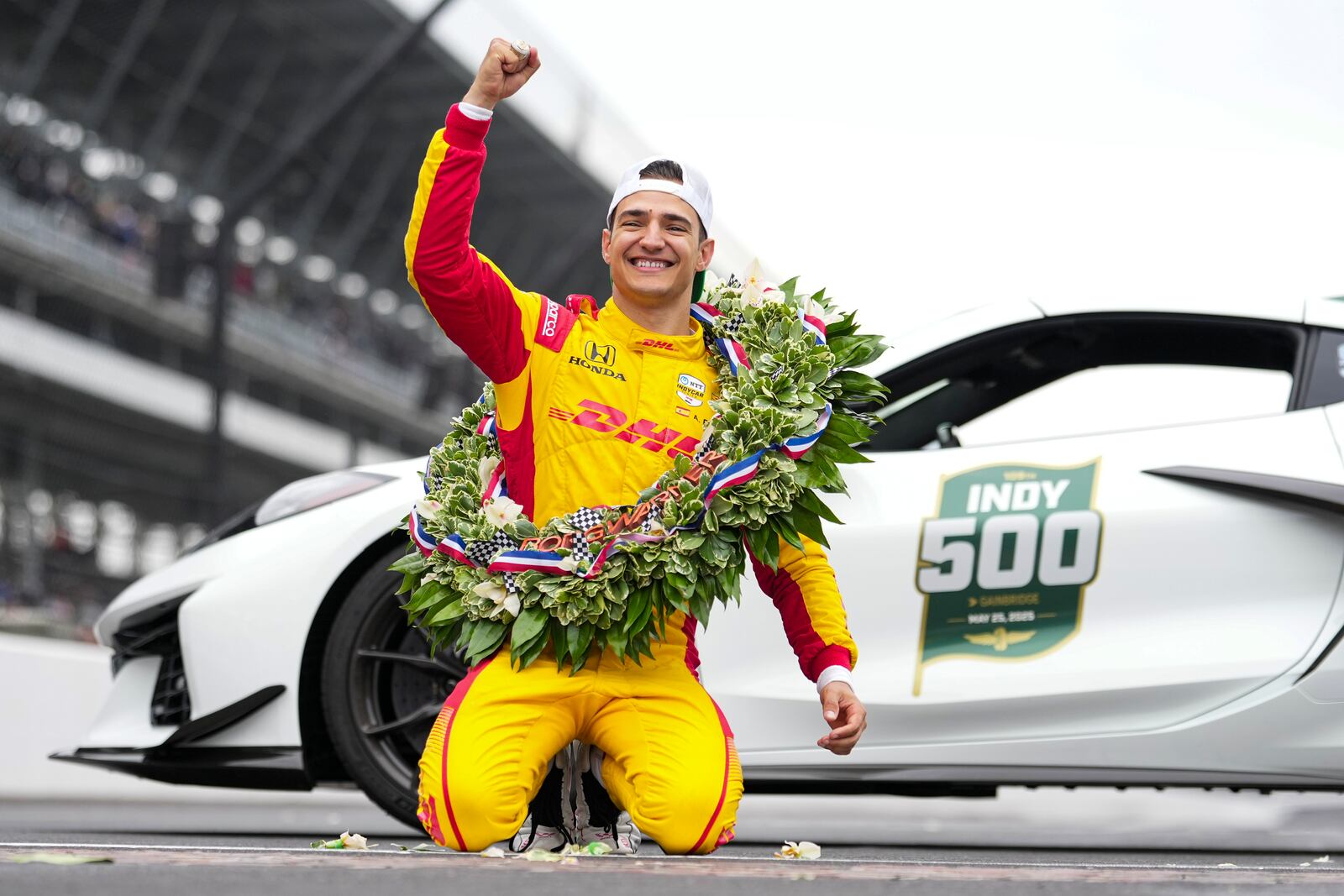 Alex Palou, of Spain, celebrates on the Yard of Bricks on the start/finish line after winning the Indianapolis 500 auto race at Indianapolis Motor Speedway in Indianapolis, Sunday, May 25, 2025. (AP Photo/AJ Mast)