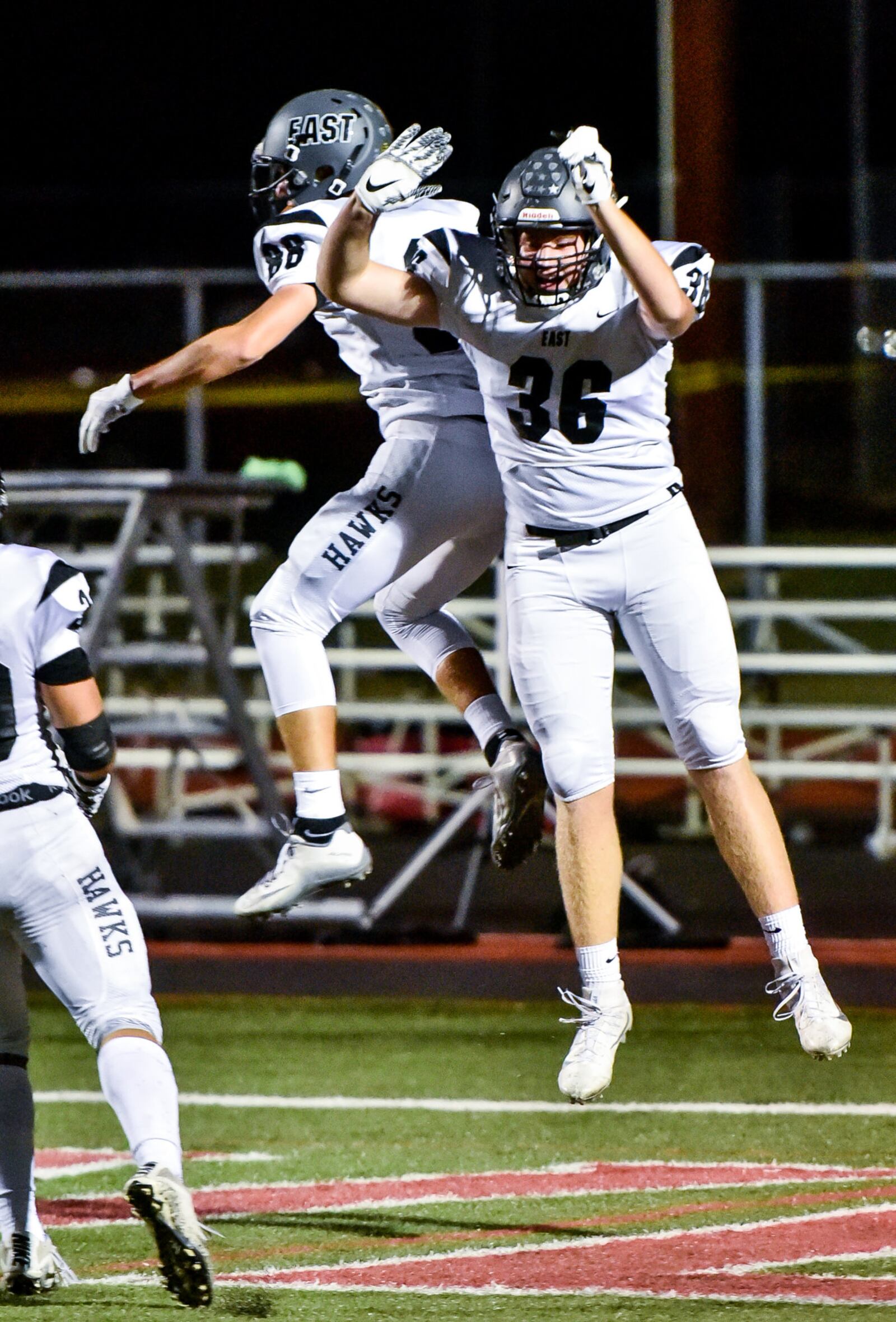 Lakota East's Evan Yablonsky (88) celebrates  his touchdown with teammate Adam Hundemer (36) during their game at Lakota West on Friday night. NICK GRAHAM/STAFF