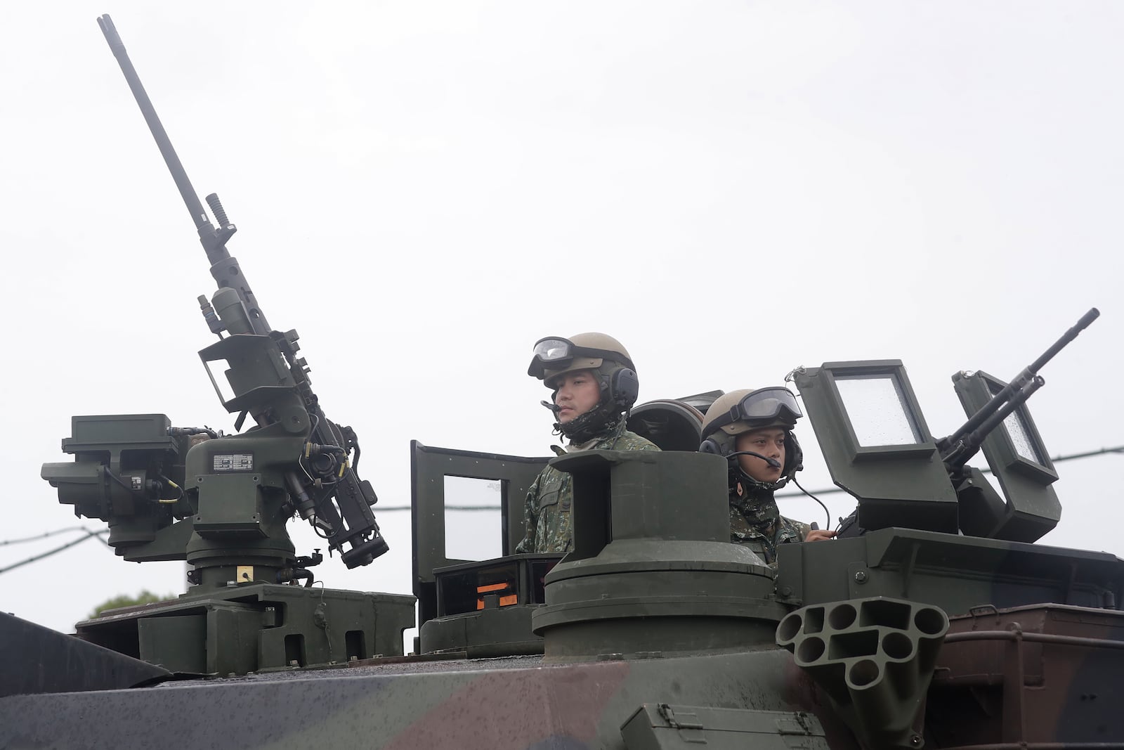 Soldiers stand by on the M1A2T Abrams main battle tanks during a military live-fire shooting training in Hsinchu County, Taiwan, Thursday, July 10, 2025. (AP Photo/Chiang Ying-ying)