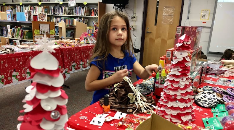 For the first time in decades a Santa Shop was opened in Fairfield West Elementary to allow all 820 students at the school to purchase gifts for their parents and family members at reduced prices. The volunteer effort also allows students from low-income families to know the joy of Christmas giving. MICHAEL D. CLARK/STAFF