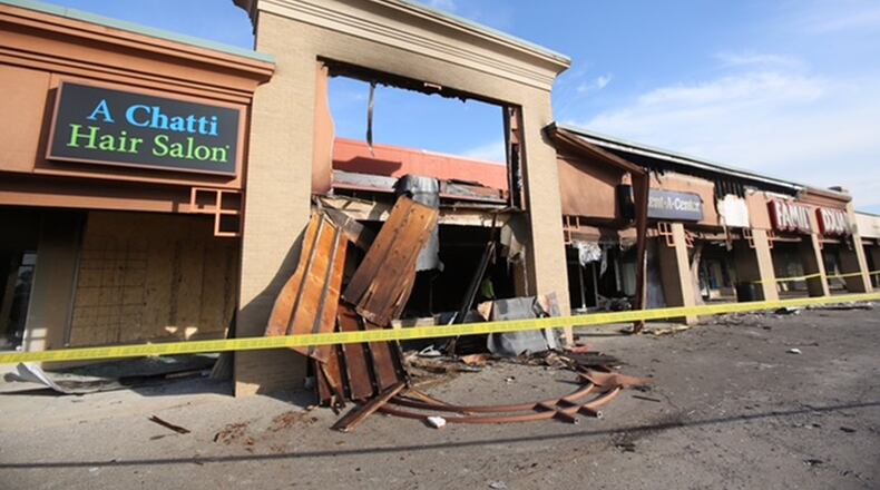 Hamilton Firefighters battled a blaze early Tuesday morning that erupted in the Rent-A-Center on Dixie Highway in the Hamilton Plaza. Flames were shooting out of the store front when first responders arrived. Two other businesses sustained damage and remained closed Friday. GREG LYNCH/STAFF