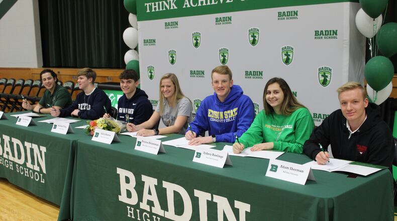 Seven student-athletes from Badin High School penned their athletic commitments for college on Wednesday, Feb. 5, at the school’s Winter Signing Reception in Mulcahey Gym. From far left are seniors Dylan Ballauer (baseball, Huntington University), Alex DeLong (football, Butler University), Marshall Flaig (football, Marian University), Kelly Havens (women’s soccer, Murray State University), Preston Heintzman (baseball, Edison State Community College), Sydney Rawlings (softball, Point Park University) and Adam Sherman (swimming, Ball State University). CONTRIBUTED