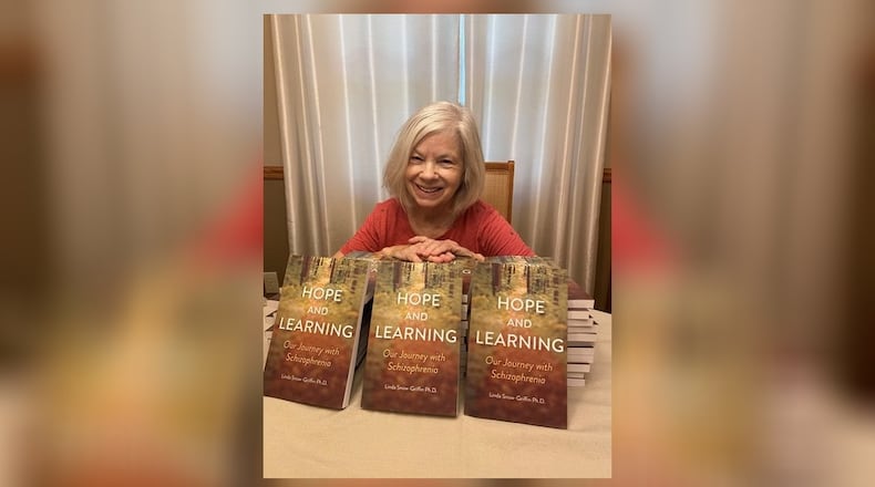 Linda Snow-Griffin with her book about people living with schizophrenia.